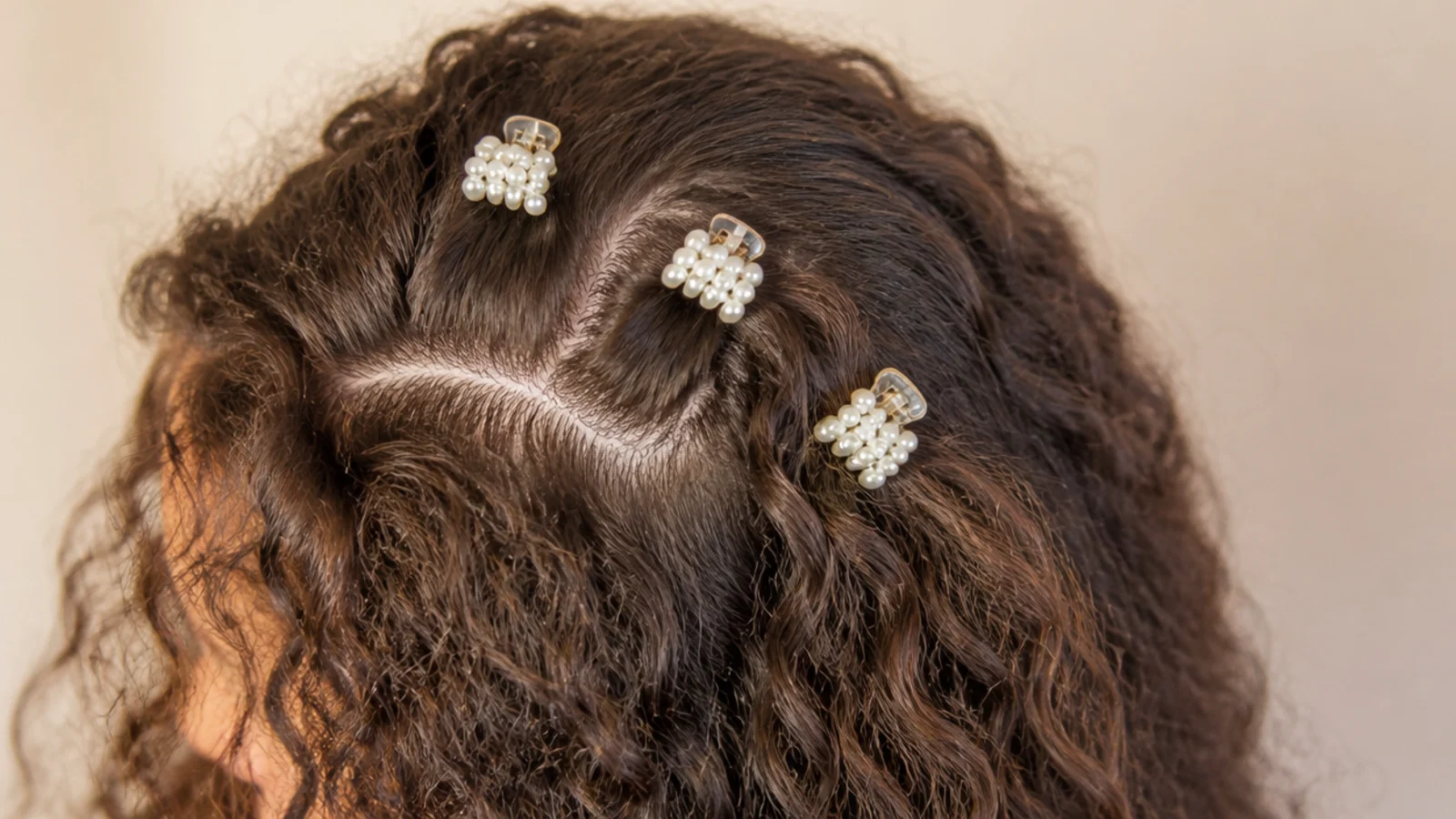 Three small claw clips holding sections back along one side of the head