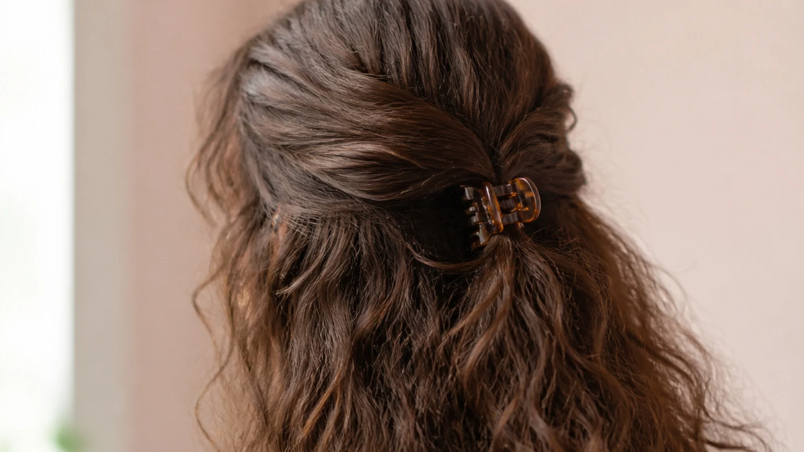 Dense hair twisted into a rope and secured with a large claw clip