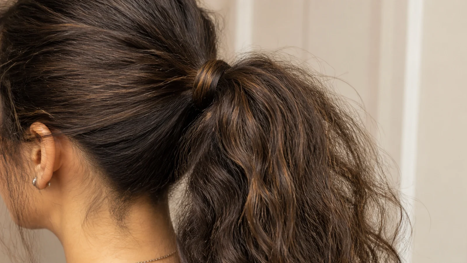 A high ponytail with a section of hair wound around the base