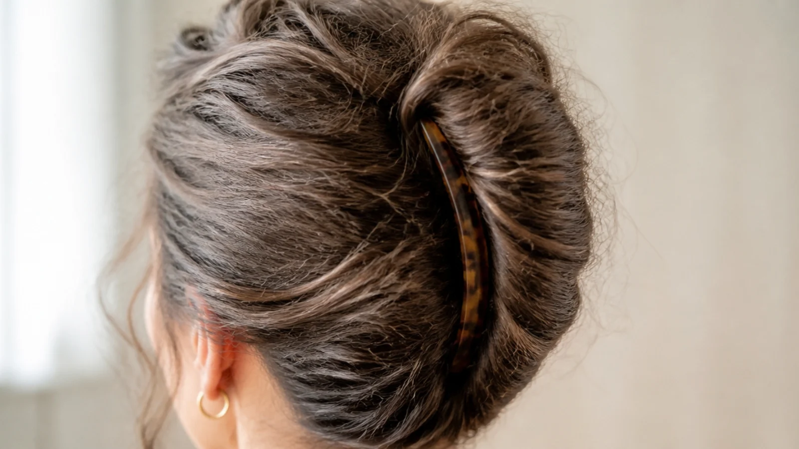 A vertical French twist pinned up the back of the head