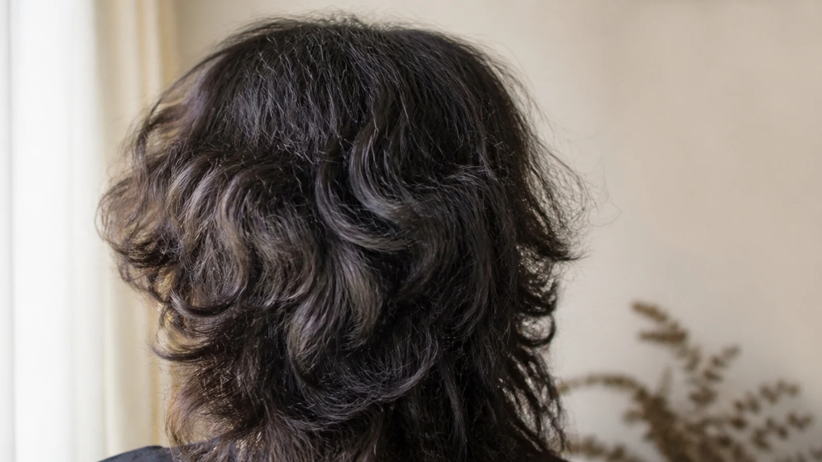 A shaggy layered cut with feathered crown pieces and longer lengths past the shoulders