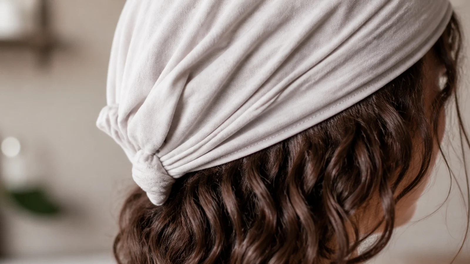 Hair piled onto a t shirt laid flat on a counter, mid wrap