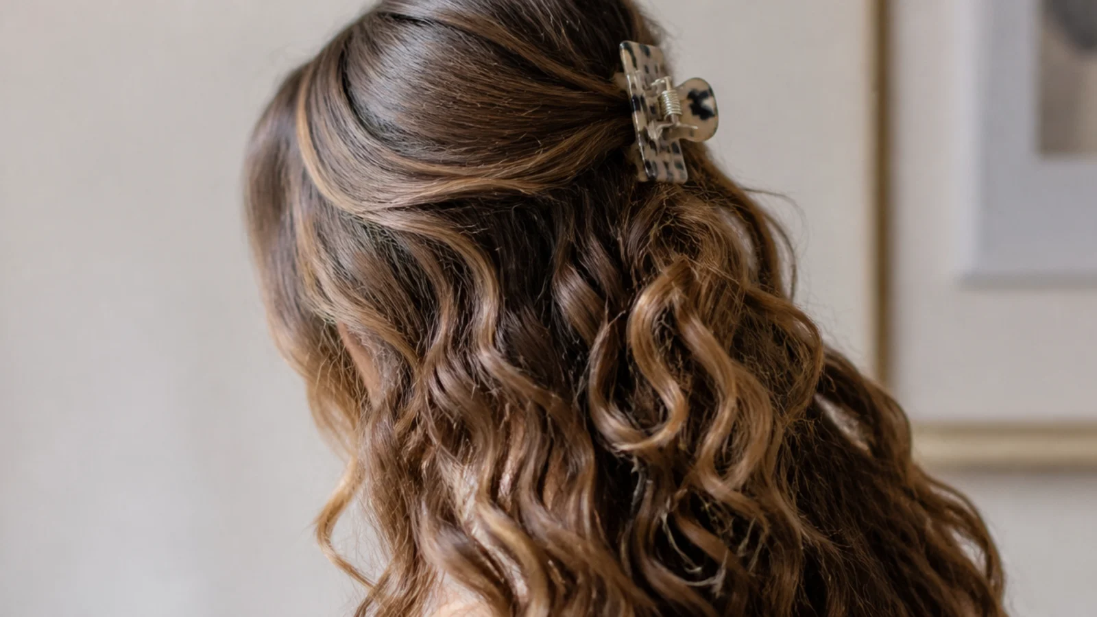 The top section twisted and clipped at the back of the head with the length left loose