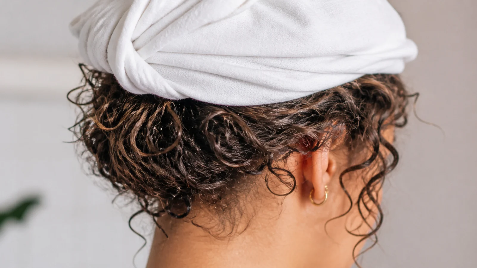 Wet hair stacked onto a flat cotton t shirt ready to be wrapped