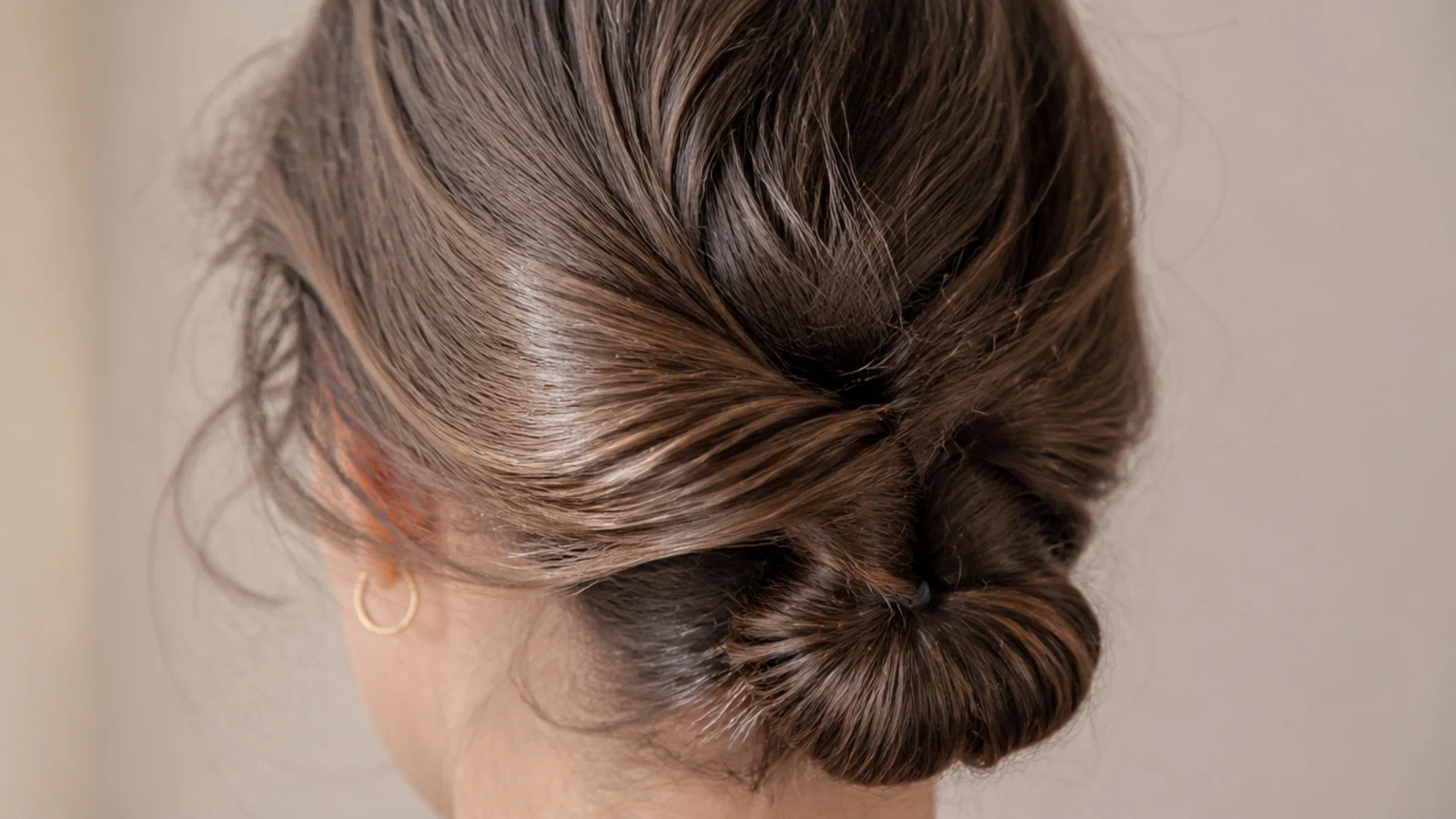 Hair twisted into a coil at the back of the head and secured with two pins
