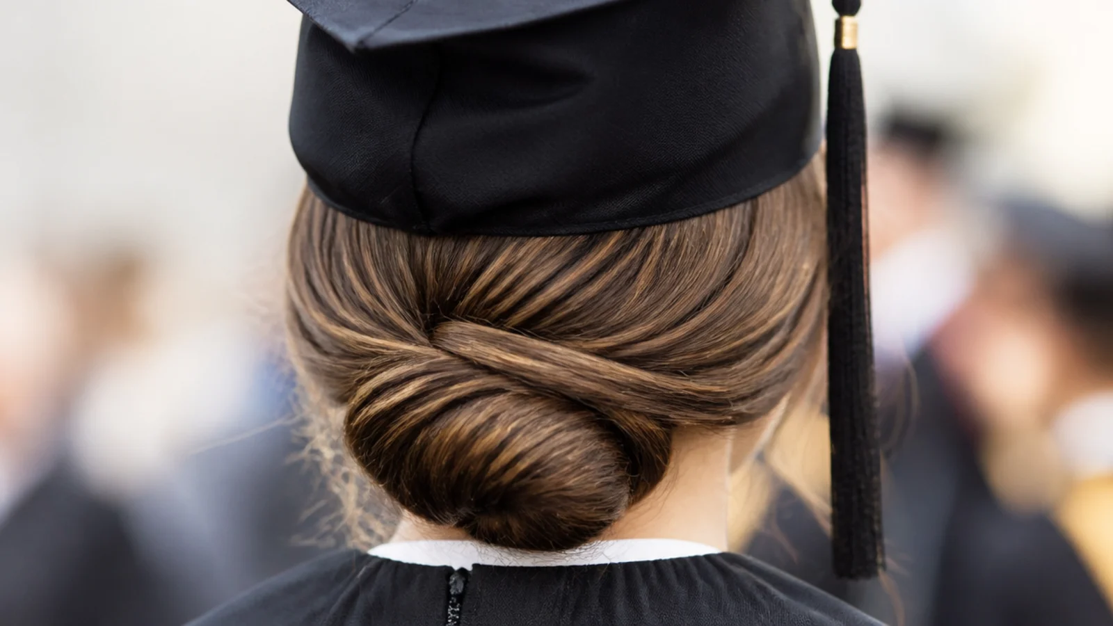 A smooth rolled chignon pinned low at the back of the head