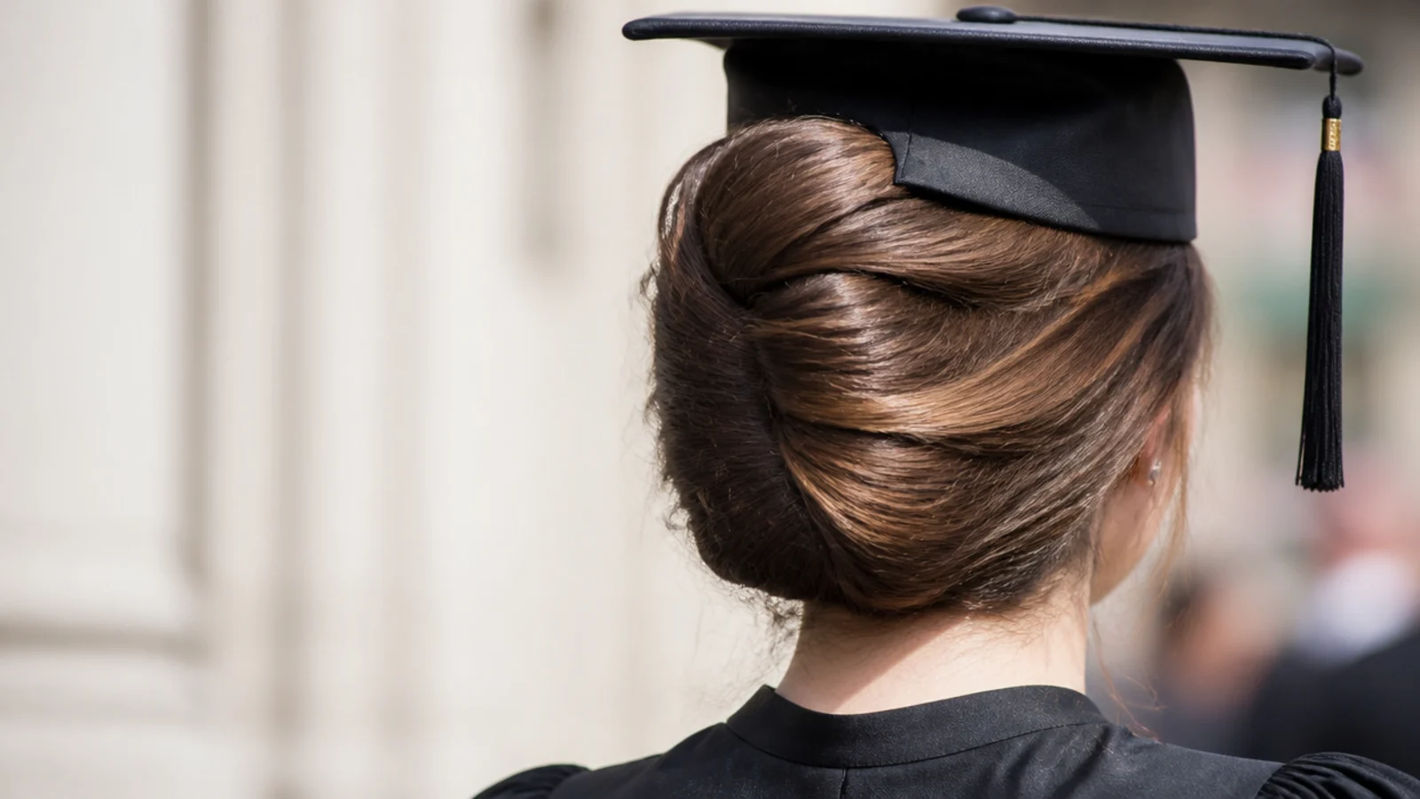 Long hair rolled into a vertical twist against the back of the head
