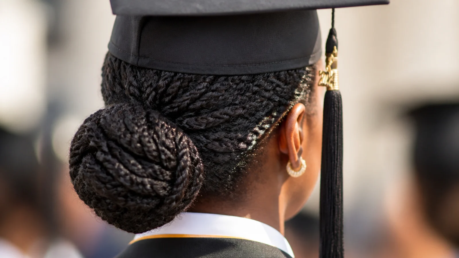 Flat twists running back along the scalp into a gathered bun at the neck