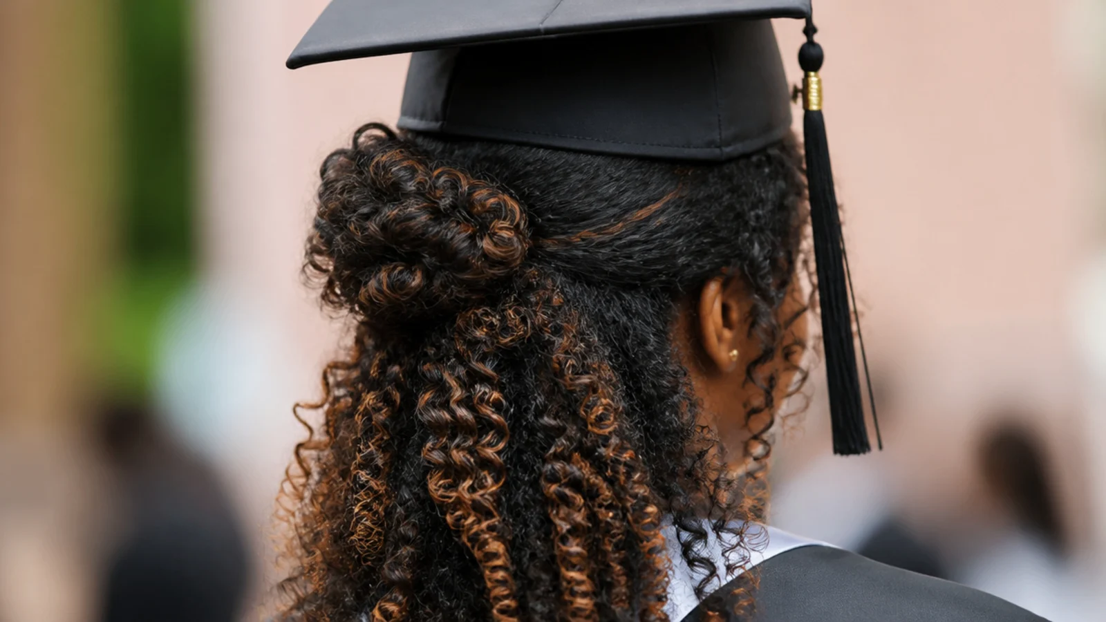 Coils gathered into a rounded puff with the rest of the hair left out