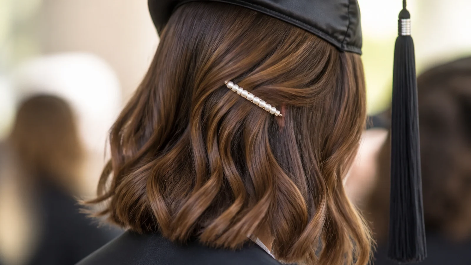 A pearl barrette clipped into the side of a short cut