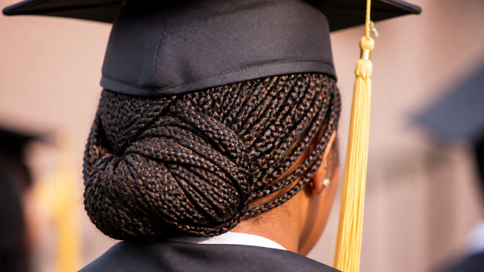 Long knotless braids gathered into a bun at the nape