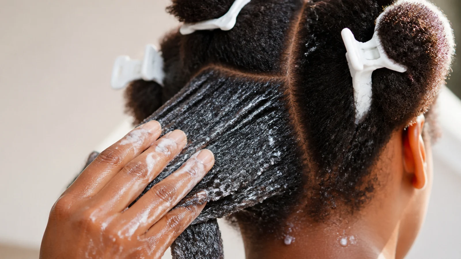Hair parted into four clipped quadrants before detangling