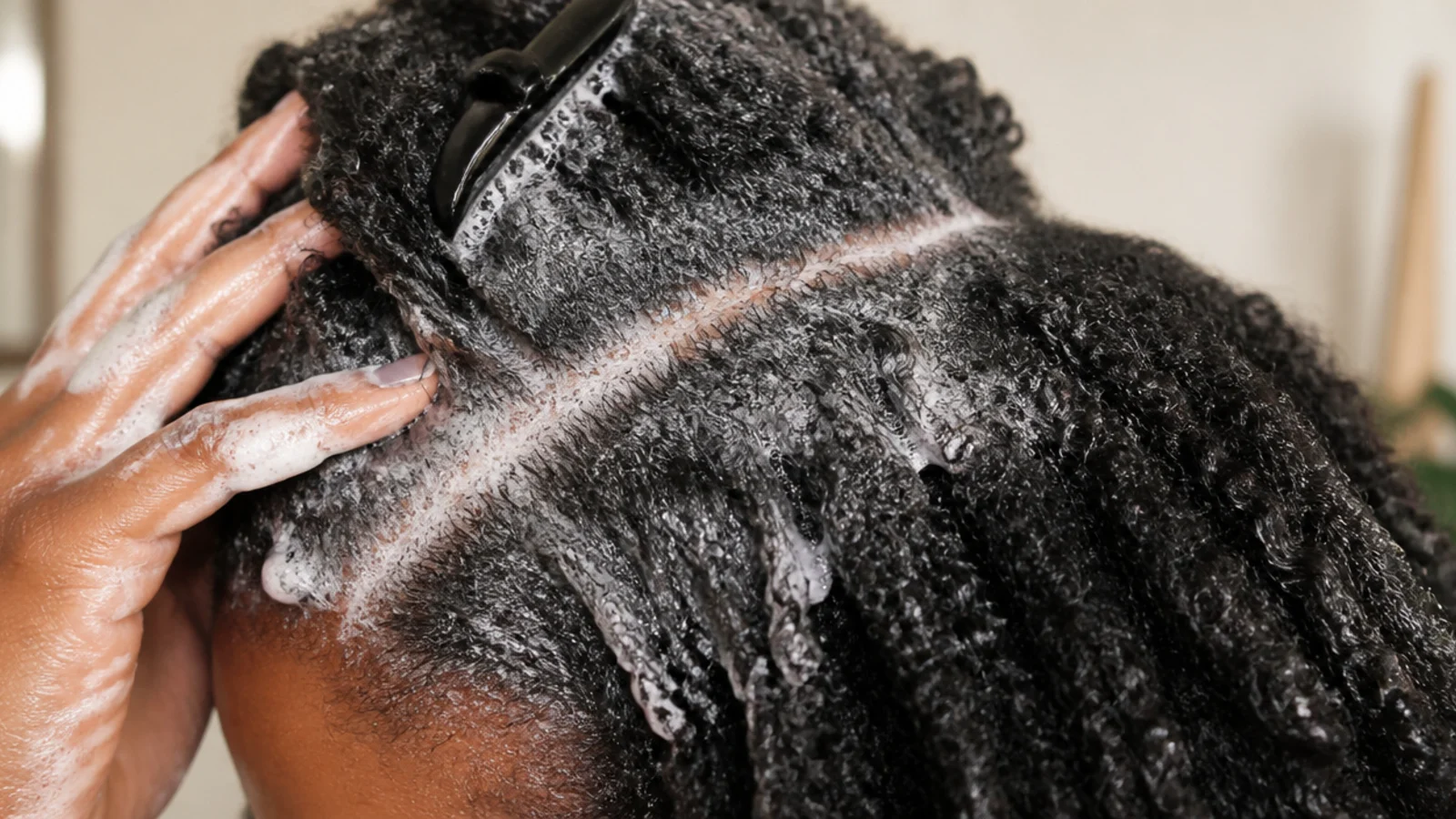 Hair being rinsed section by section at the basin