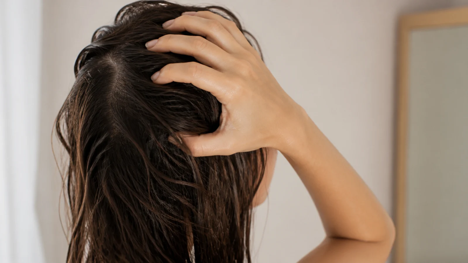 Wet hair being squeezed gently rather than rubbed