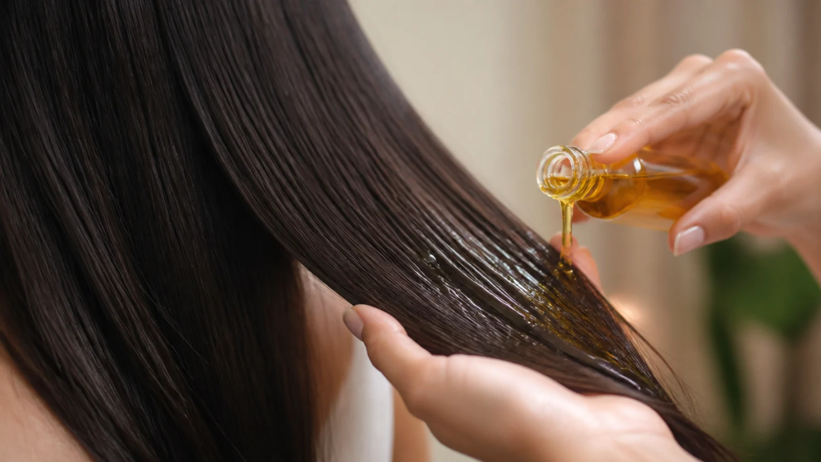 Viscous castor oil pouring from a small glass bottle