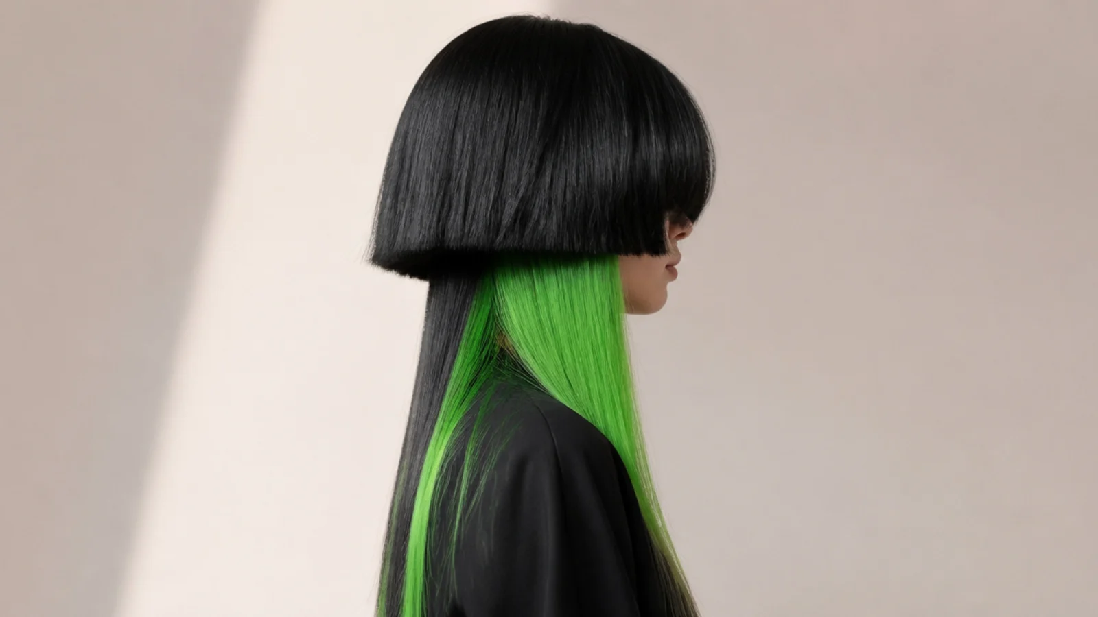 Bright green colour showing through the underside of dark long hair as it lifts