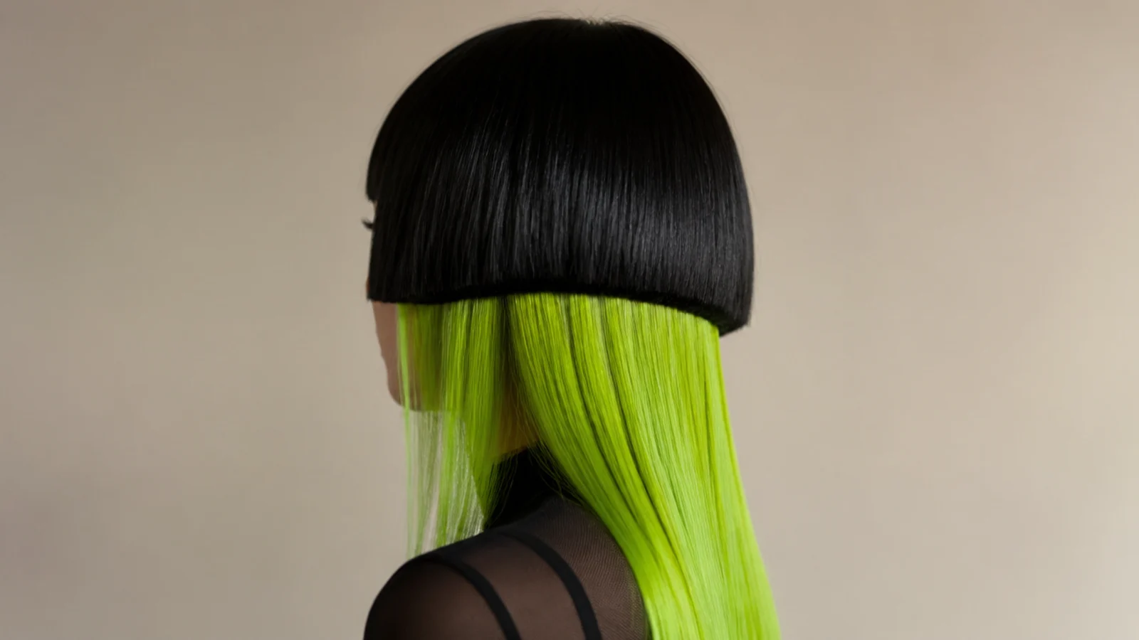Vivid green length falling below a dark rounded top layer