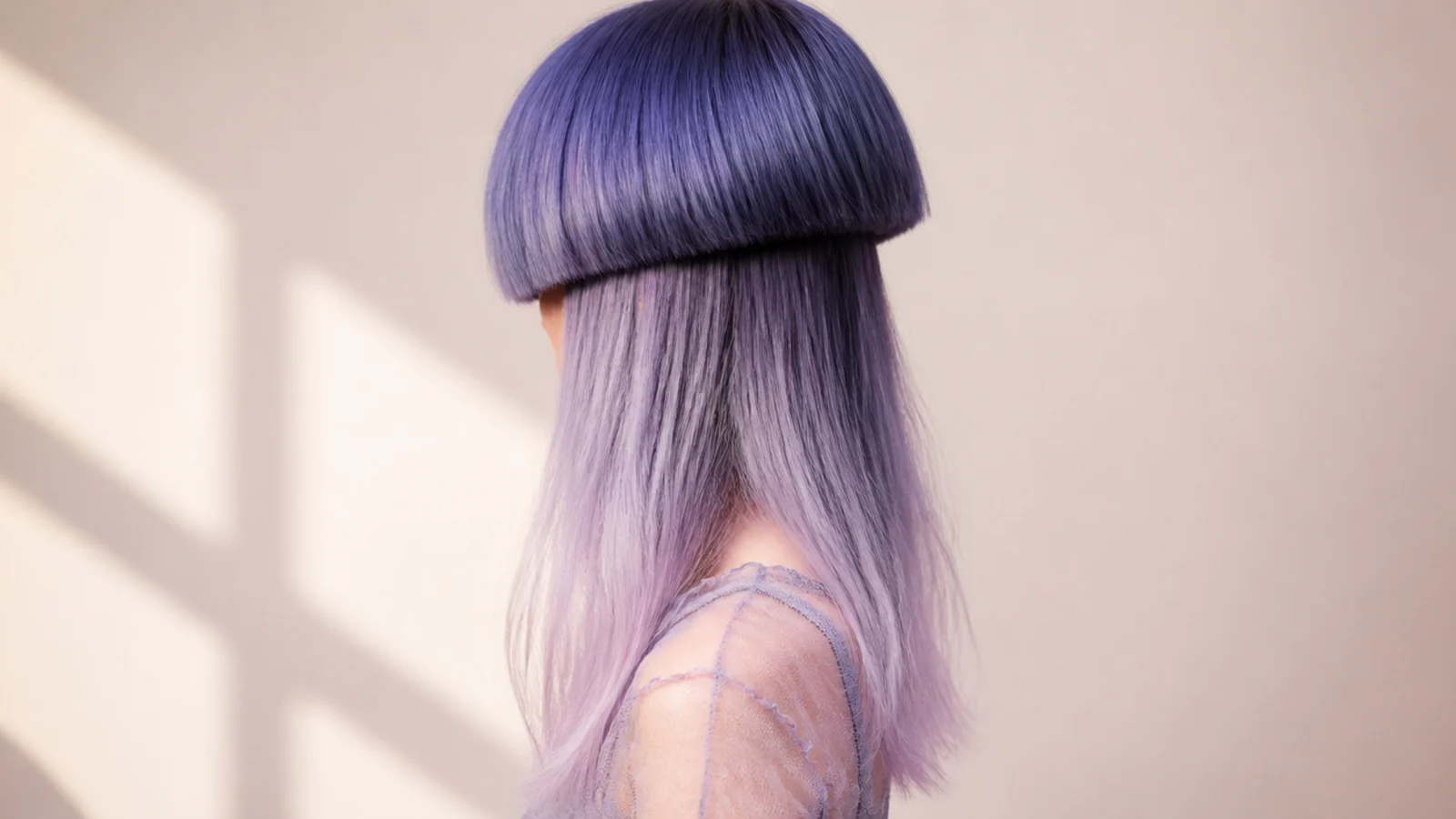 Deep blue at the roots melting into pale lavender through the long lower lengths