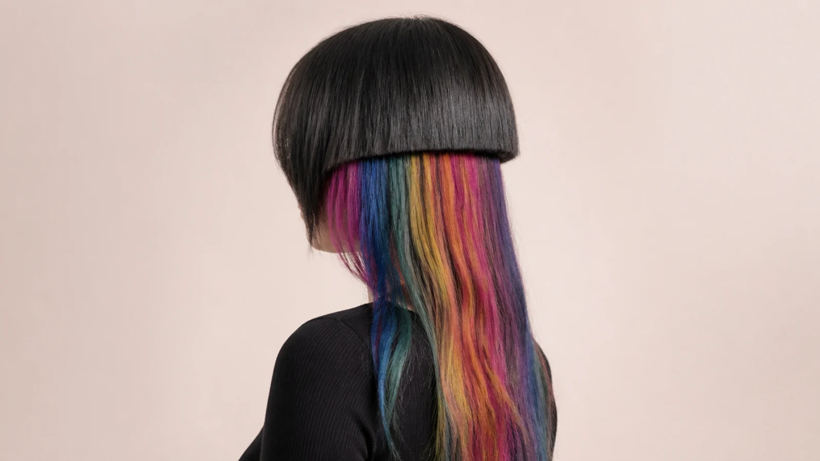 Bands of several bright colors revealed beneath a lifted dark top layer