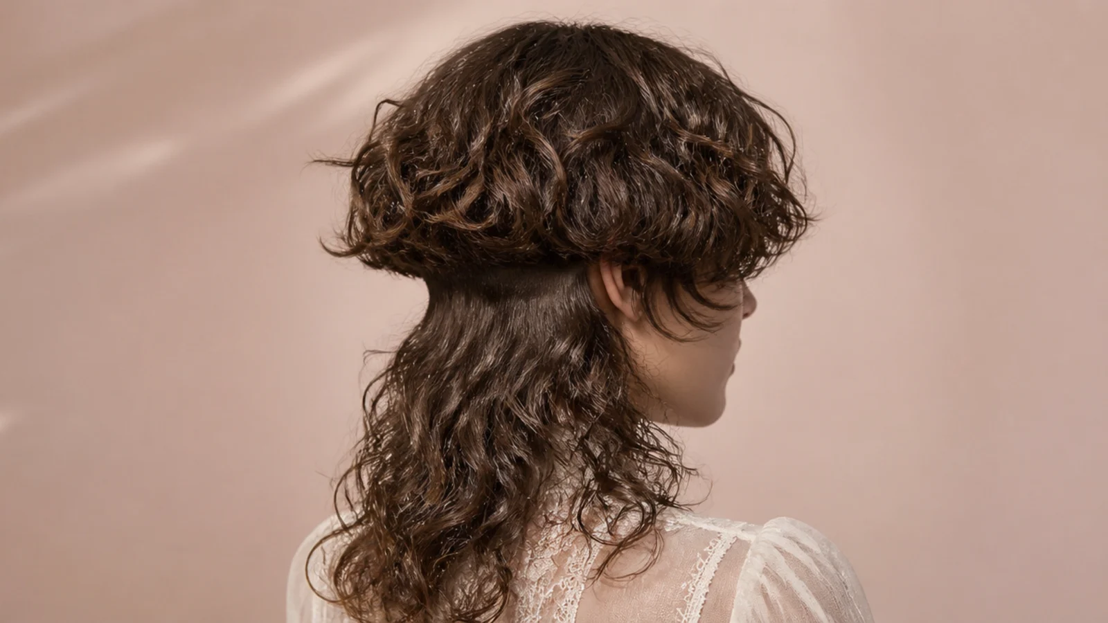 Curls lifted at the nape to show a clipped section underneath