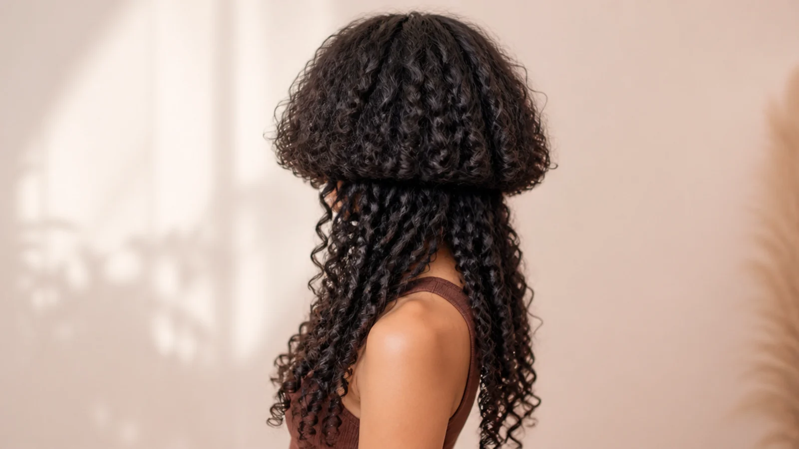 Thick coarse curls forming a full rounded top section over long hair