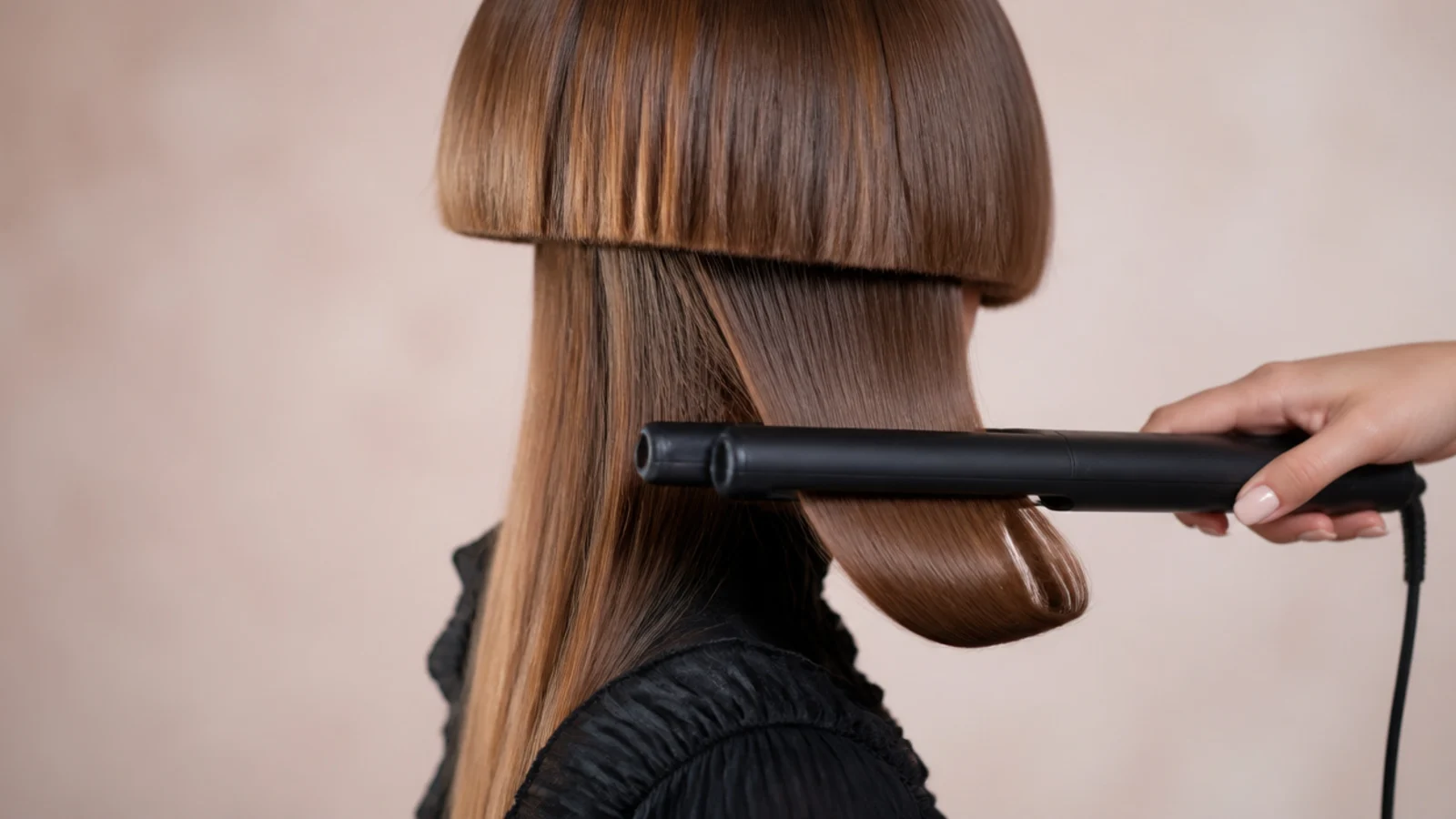 A flat iron bending the ends of the top layer inward toward the neck