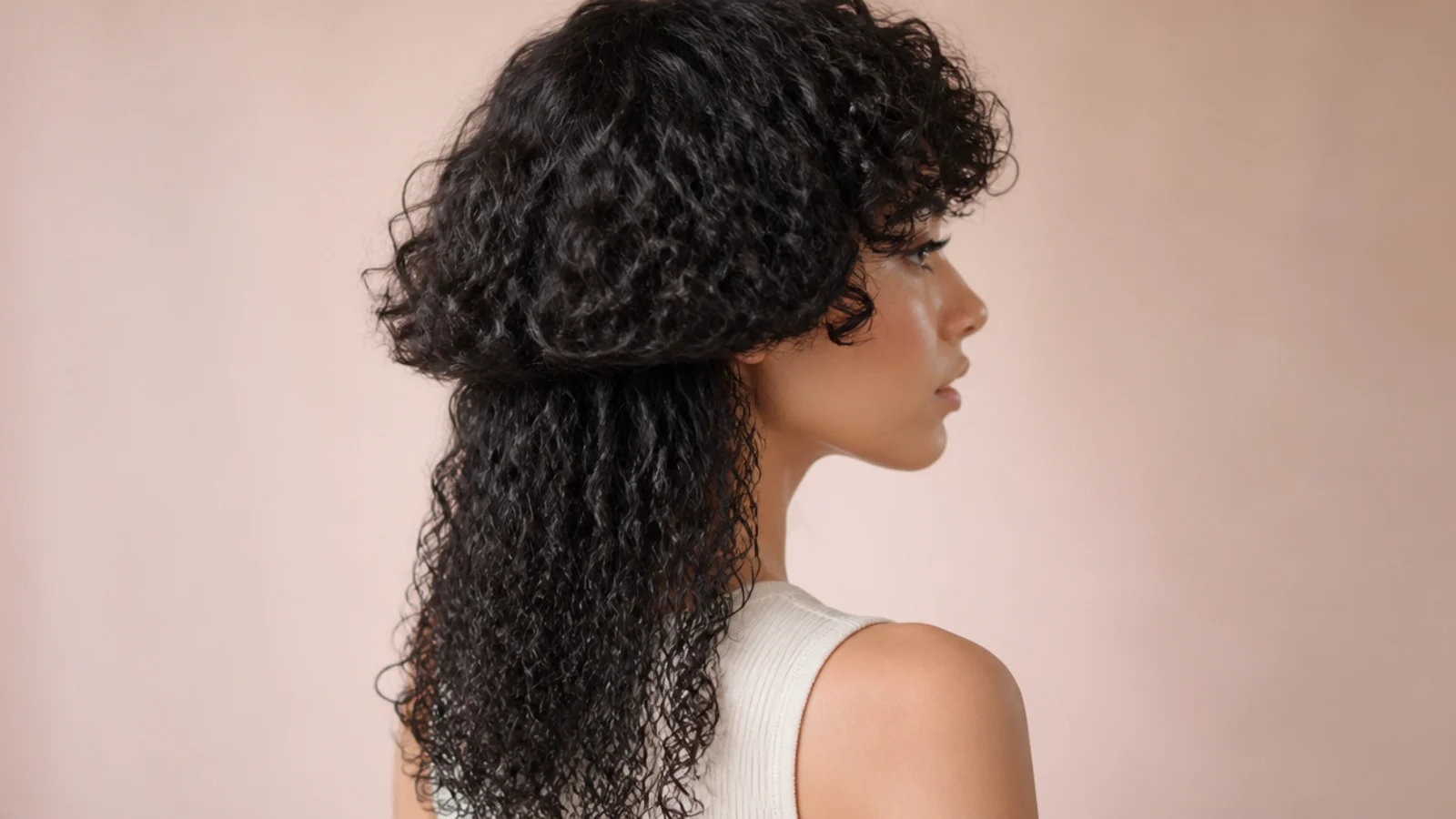 Springy curls forming a short fringe over the forehead