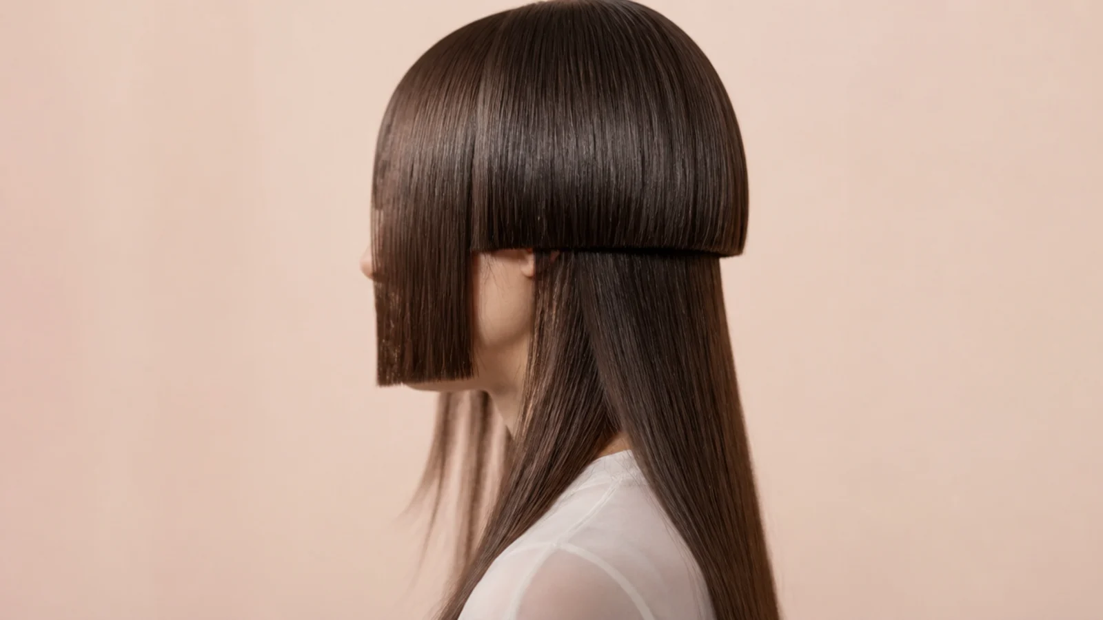 Straight blunt side panels framing the face beside longer hair