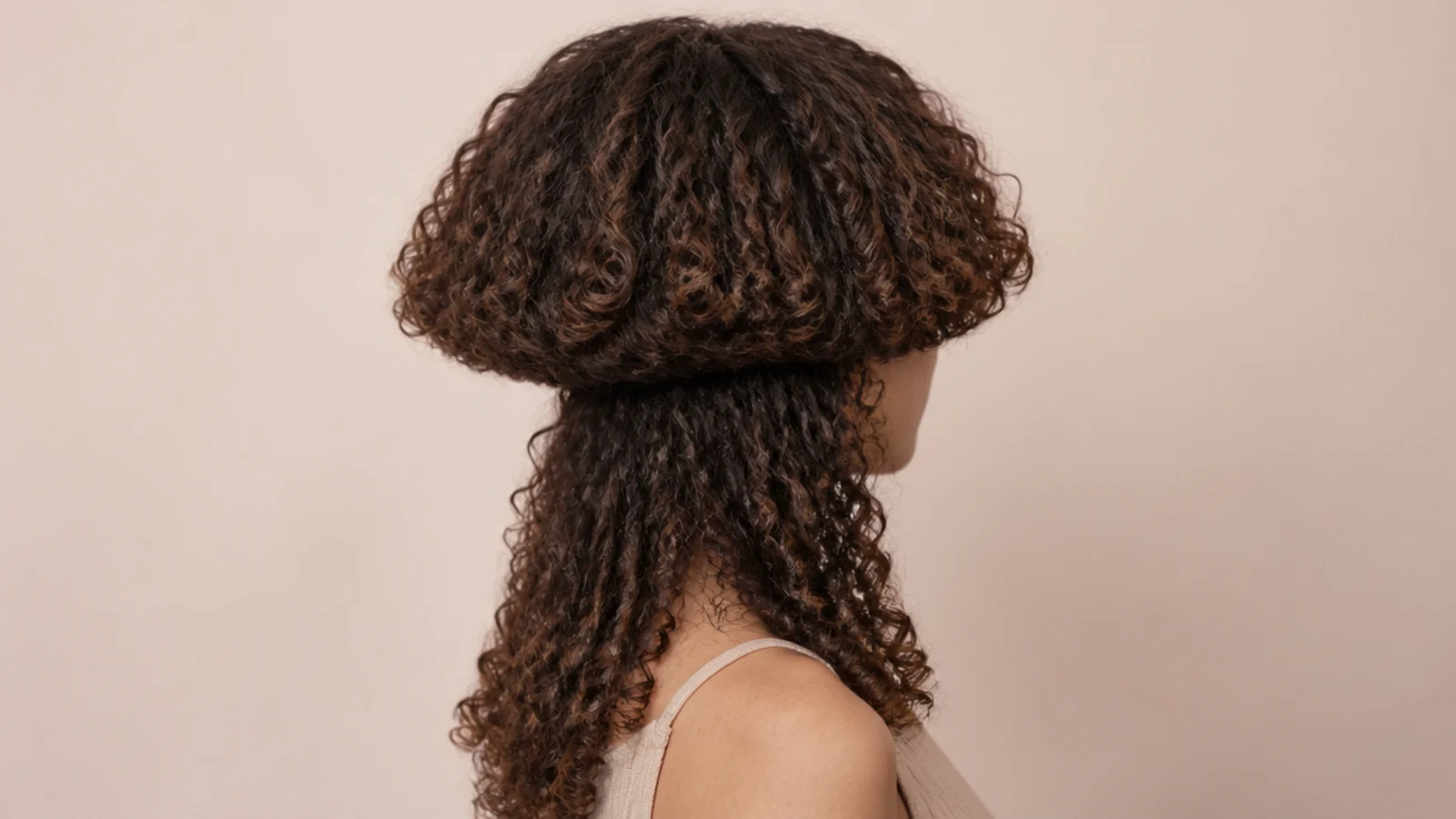 Loose spiral curls in both tiers of a medium length cut