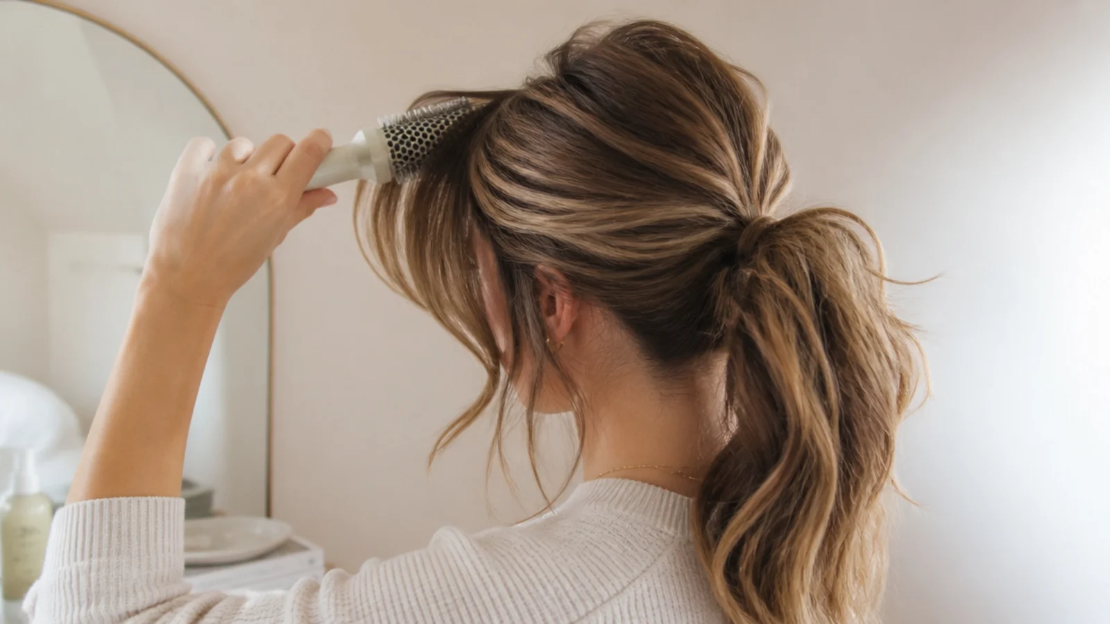 A round brush sweeping a curtain fringe outward while drying
