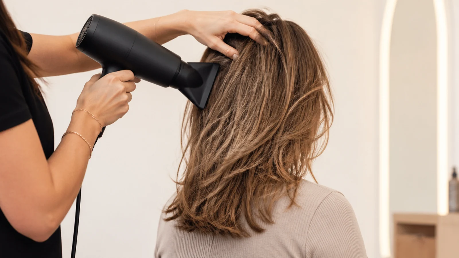 Hair being rough dried with fingers lifting at the roots