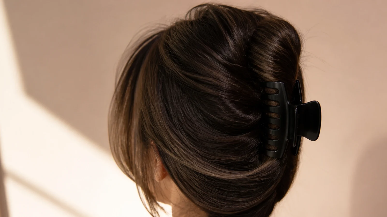 Black hair twisted up and held in a large claw clip