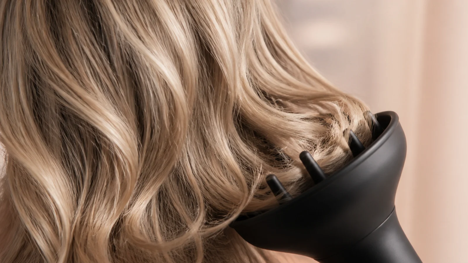 Hair cupped inside a diffuser bowl at the side of the head