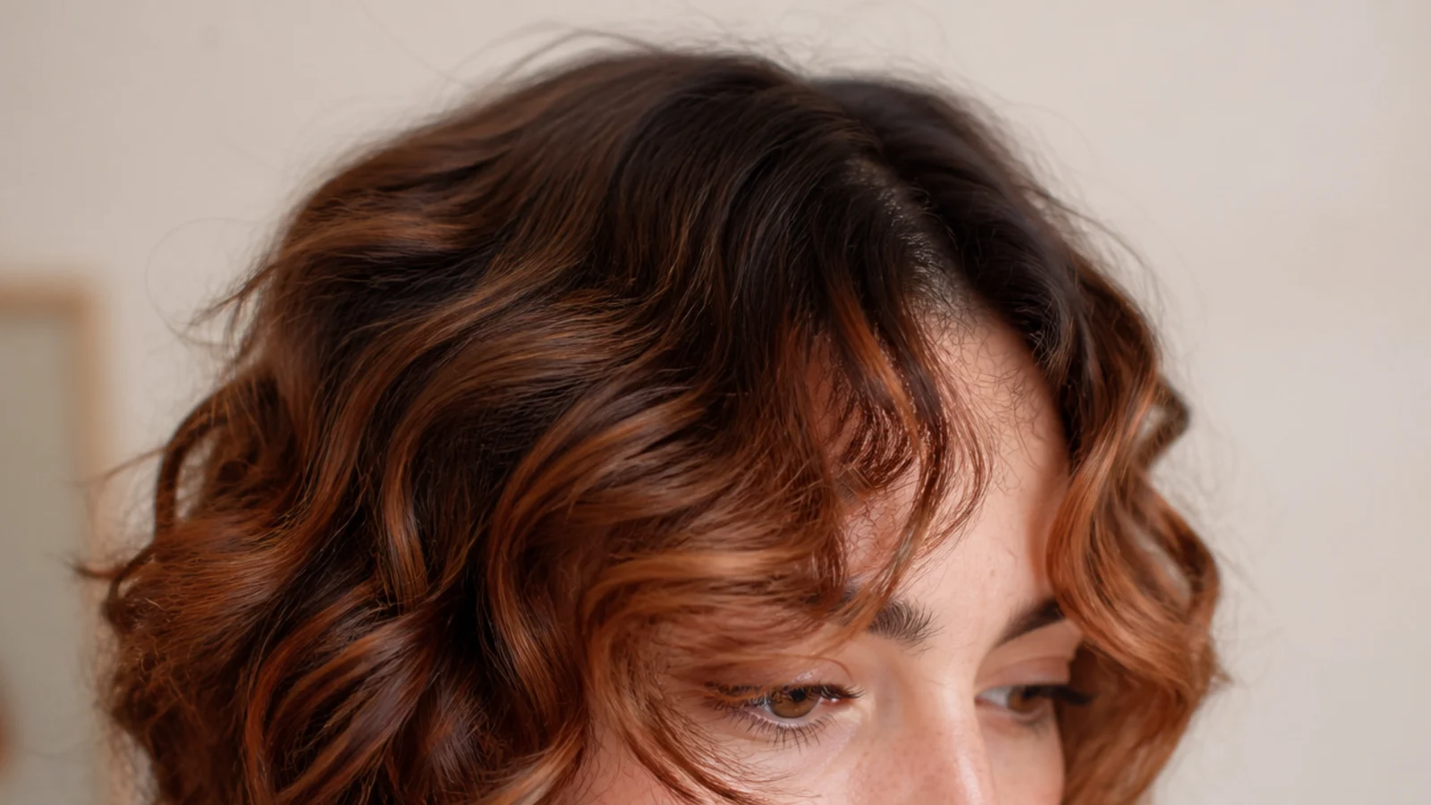 Copper toned curls painted lighter through the fringe pieces