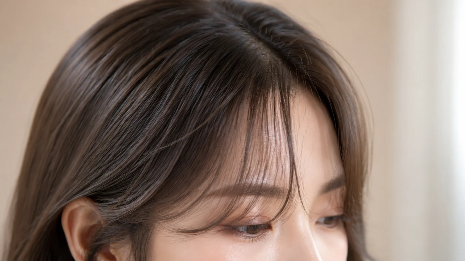 A soft fringe grazing the eyelashes with the ends curling outward