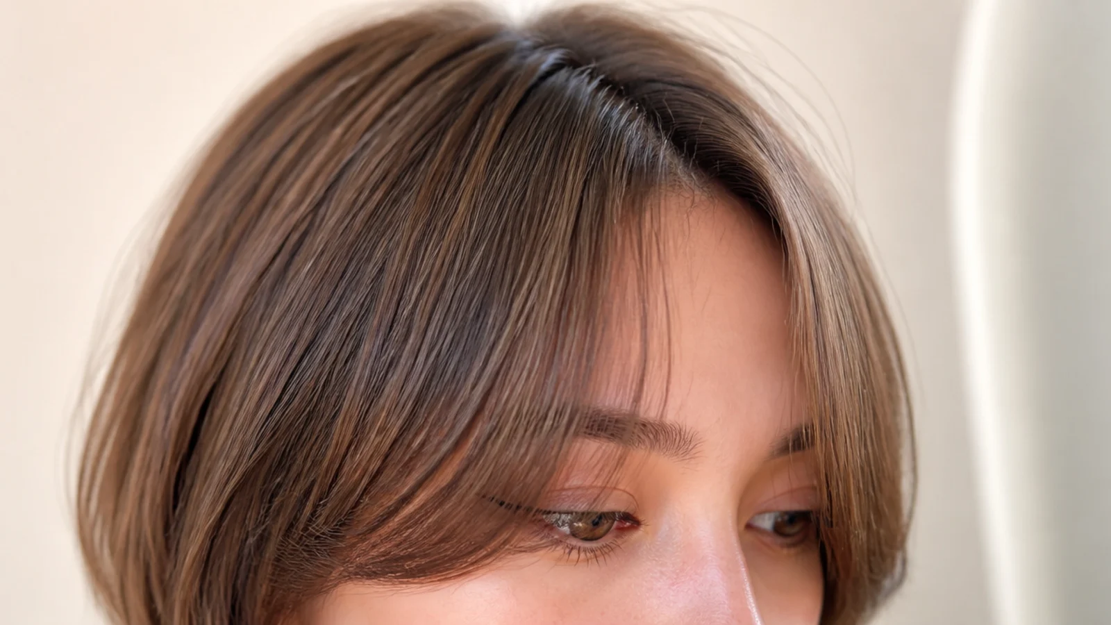 Close view of a U-shaped fringe curving around the face on a bob