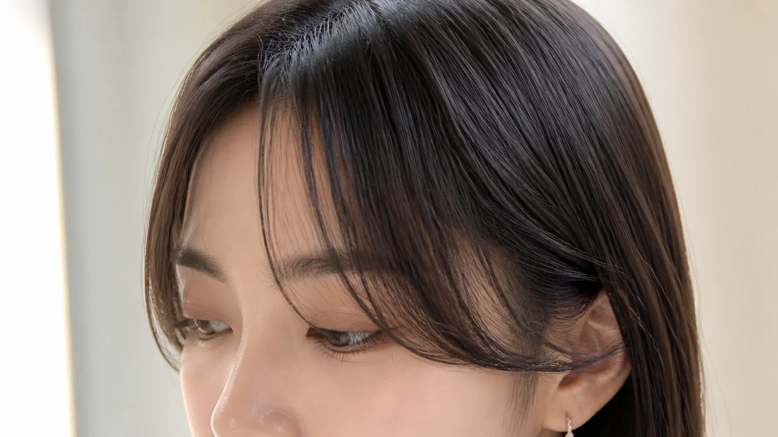 A wispy fringe with forehead visible between the strands