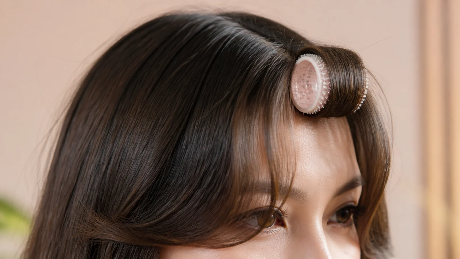 A damp short fringe wound onto a heatless roller
