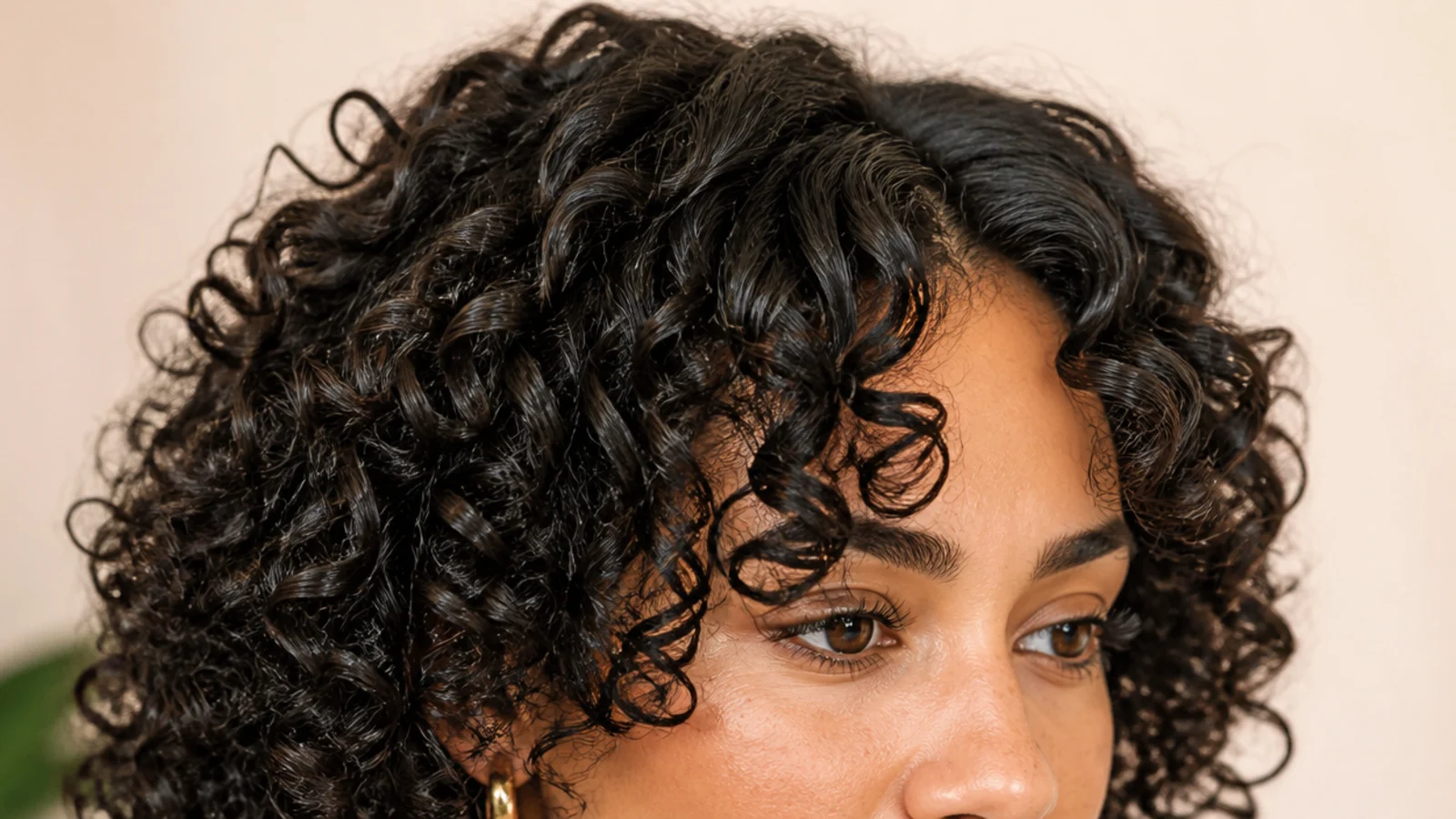Defined curls parted in the middle with shorter spirals framing the forehead