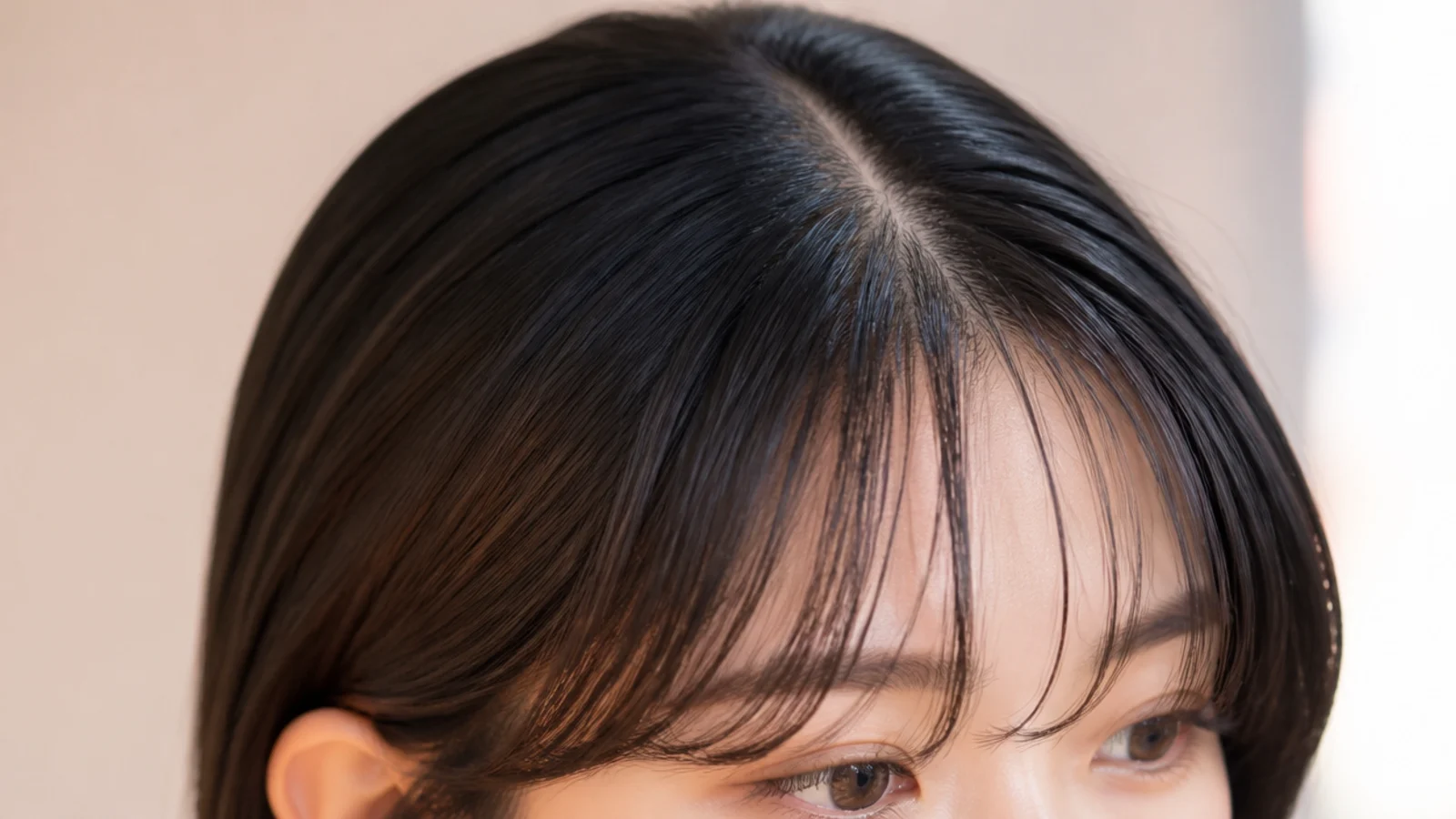 Sleek straight hair with a fine centre-split fringe and no visible hard edge