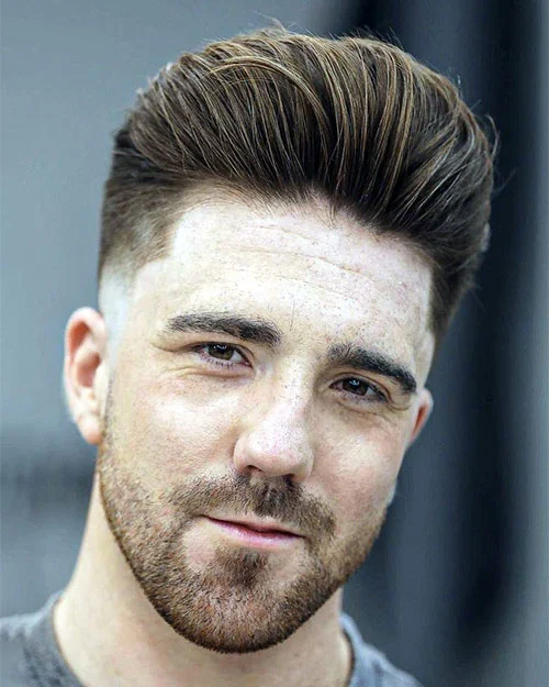 Textured Pompadour with Low Skin Fade and Heavy Stubble Beard