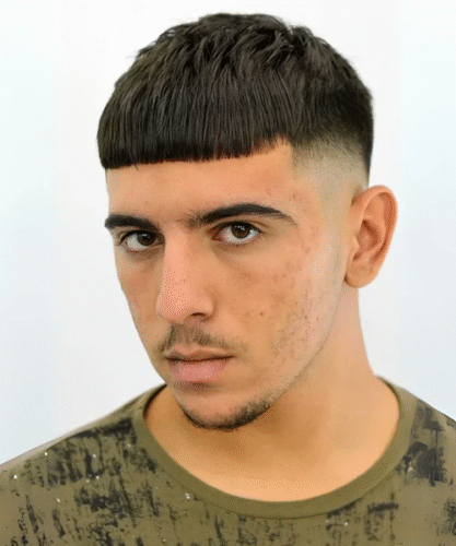 Taper fade fringe haircut with blunt front and sculpted sides