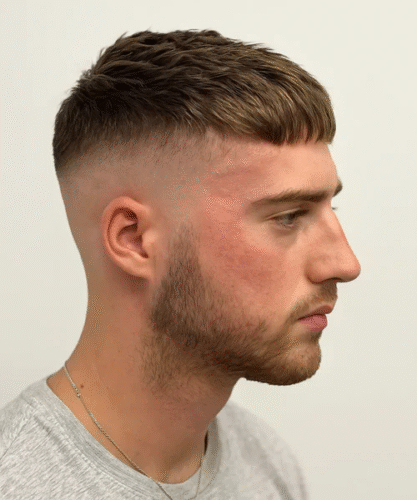 Classic Caesar haircut with blunt fringe and clean faded sides